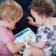 Two young children looking at an iPad